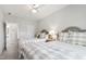 Bright bedroom featuring two beds with plush bedding, neutral decor, and ample natural light, offering a serene and restful ambiance at 102 Bella Rose Drive, Chapel Hill, NC 27517