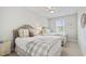 Bedroom featuring twin beds with neutral decor, a ceiling fan, and a window, creating a cozy and comfortable space at 102 Bella Rose Drive, Chapel Hill, NC 27517