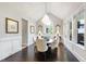 Elegant dining room with a chandelier, wainscoting, and beautiful windows at 102 Bella Rose Drive, Chapel Hill, NC 27517