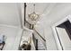 Elegant foyer boasting a staircase, modern chandelier, and access to main living spaces at 102 Bella Rose Drive, Chapel Hill, NC 27517