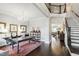 Elegant foyer featuring hardwood floors, a chandelier, and a staircase leading to the upper level at 102 Bella Rose Drive, Chapel Hill, NC 27517