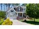 Beautiful two-story home with stone and gray siding, a well-manicured lawn, and a two-car garage at 102 Bella Rose Drive, Chapel Hill, NC 27517