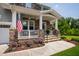 Charming front porch with stone and gray siding, perfect for relaxing and enjoying the outdoors at 102 Bella Rose Drive, Chapel Hill, NC 27517