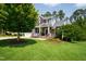 Charming two-story home featuring stone accents, a well-manicured lawn, and inviting curb appeal at 102 Bella Rose Drive, Chapel Hill, NC 27517
