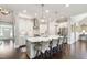 Bright, open kitchen featuring a large marble island with seating and stainless steel appliances at 102 Bella Rose Drive, Chapel Hill, NC 27517