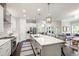 Bright, open kitchen featuring a large marble island with seating and stainless steel appliances at 102 Bella Rose Drive, Chapel Hill, NC 27517