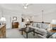 Bright living room featuring a ceiling fan, comfortable seating, and access to an upper level, exuding a cozy and welcoming atmosphere at 102 Bella Rose Drive, Chapel Hill, NC 27517