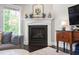 Comfortable living room featuring a fireplace, mantle and stylish decor at 102 Bella Rose Drive, Chapel Hill, NC 27517