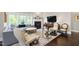 Inviting living room features a cozy fireplace, large windows, and stylish, comfortable seating at 102 Bella Rose Drive, Chapel Hill, NC 27517
