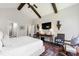Stylish main bedroom featuring vaulted ceiling, exposed beams, seating area, and ensuite bath at 102 Bella Rose Drive, Chapel Hill, NC 27517