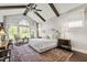 Bright main bedroom with vaulted ceiling, exposed beams, ceiling fan, and large windows at 102 Bella Rose Drive, Chapel Hill, NC 27517