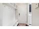 Mudroom featuring bench seating and storage, leading to the laundry room at 102 Bella Rose Drive, Chapel Hill, NC 27517