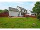 Spacious backyard featuring a patio area, green lawn, and privacy fencing at 102 W Hill Dr, Cary, NC 27519