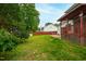 Expansive backyard featuring lush greenery, a brick patio, and a wooden fence, offering privacy and a serene outdoor setting at 102 W Hill Dr, Cary, NC 27519