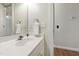 Clean bathroom featuring a white vanity, mirror, and natural light, creating a comfortable and functional space at 102 W Hill Dr, Cary, NC 27519
