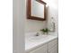 Bright bathroom featuring a white vanity, a mirror, and a towel ring, creating a clean and functional space at 102 W Hill Dr, Cary, NC 27519