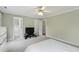 Spacious bedroom with a ceiling fan, neutral walls, and access to an en-suite bathroom at 102 W Hill Dr, Cary, NC 27519