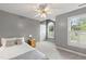 Spacious bedroom with neutral tones, two windows, ceiling fan, and plenty of natural light at 102 W Hill Dr, Cary, NC 27519