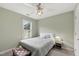 Comfortable bedroom with a ceiling fan, window with shutters, and a well-lit and inviting atmosphere at 102 W Hill Dr, Cary, NC 27519