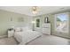Comfortable bedroom with soft carpeting, dual windows, ceiling fan, and closet at 102 W Hill Dr, Cary, NC 27519
