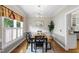 Elegant dining room with wallpapered accent wall, decorative molding, chandelier, and natural light at 102 W Hill Dr, Cary, NC 27519