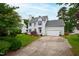 Beautifully landscaped home with a two-car garage, and a well-maintained lawn at 102 W Hill Dr, Cary, NC 27519