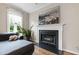Living room featuring a fireplace and plush grey couch at 102 W Hill Dr, Cary, NC 27519