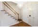 Bright foyer with hardwood floors, chandelier, and stairs with hardwood trim at 102 W Hill Dr, Cary, NC 27519
