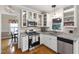 Updated kitchen with stainless steel appliances, white cabinets, and granite countertops at 102 W Hill Dr, Cary, NC 27519