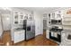 Updated kitchen featuring stainless appliances, granite counters, and white cabinetry at 102 W Hill Dr, Cary, NC 27519