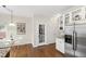 Eat-in kitchen features stainless steel appliances, breakfast table, and white cabinetry at 102 W Hill Dr, Cary, NC 27519