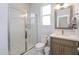 Well-lit bathroom with a glass-enclosed shower, toilet, and vanity with a decorative mirror at 1021 Benay Rd, Morrisville, NC 27560