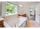 Bright bathroom with large tub, tile surround, and window at 1021 Benay Rd, Morrisville, NC 27560