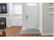 Inviting entryway with a bright white door, a fireplace, and wood flooring at 1021 Benay Rd, Morrisville, NC 27560