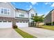 Beautiful two-story home with stone accents, a two-car garage, well-manicured lawn, and a blue sky backdrop at 1021 Benay Rd, Morrisville, NC 27560