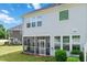 Back of a beautiful home with a screened porch and bright, large windows overlooking a lush backyard at 1021 Benay Rd, Morrisville, NC 27560