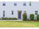 View of the front entrance surrounded by well-maintained landscaping, colorful flowers, and lush green grass at 1021 Benay Rd, Morrisville, NC 27560