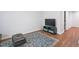 Hallway with a television and wood floors leading to a laundry room at 1021 Benay Rd, Morrisville, NC 27560