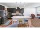 Modern kitchen featuring stainless steel appliances, a large island, dark cabinetry, and stylish lighting fixtures at 1021 Benay Rd, Morrisville, NC 27560