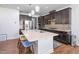 Modern kitchen features dark cabinetry, stainless steel appliances, and a large center island with seating at 1021 Benay Rd, Morrisville, NC 27560