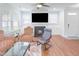 Inviting living area with a fireplace, hardwood floors, a ceiling fan, and large windows for natural light at 1021 Benay Rd, Morrisville, NC 27560