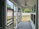 Charming screened-in porch with a ceiling fan, offering a comfortable outdoor space to enjoy the view of the backyard at 1021 Benay Rd, Morrisville, NC 27560