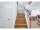 Staircase with wooden steps, white banister, and natural light offers a welcoming transition between floors at 1021 Benay Rd, Morrisville, NC 27560