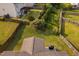 Aerial view of a fenced backyard featuring a patio with grill and lush foliage at 105 Putters Ct, Durham, NC 27703