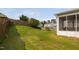Expansive backyard featuring lush green lawn, wood fence, and a screened-in porch for outdoor enjoyment at 105 Putters Ct, Durham, NC 27703