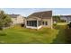 Aerial view of a lush backyard, patio area with grill, and a screened in porch at 105 Putters Ct, Durham, NC 27703