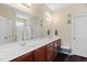 Bathroom with double sinks, large mirror, vanity lighting, and a walk-in shower at 105 Putters Ct, Durham, NC 27703