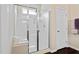 Bright bathroom featuring a shower with glass doors and a built-in bench at 105 Putters Ct, Durham, NC 27703