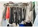 A fully stocked walk-in closet with clothing hanging on rods and storage above at 105 Putters Ct, Durham, NC 27703