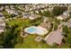 Aerial view of the community pool with a kiddie pool, lounge chairs, and a playground at 105 Putters Ct, Durham, NC 27703